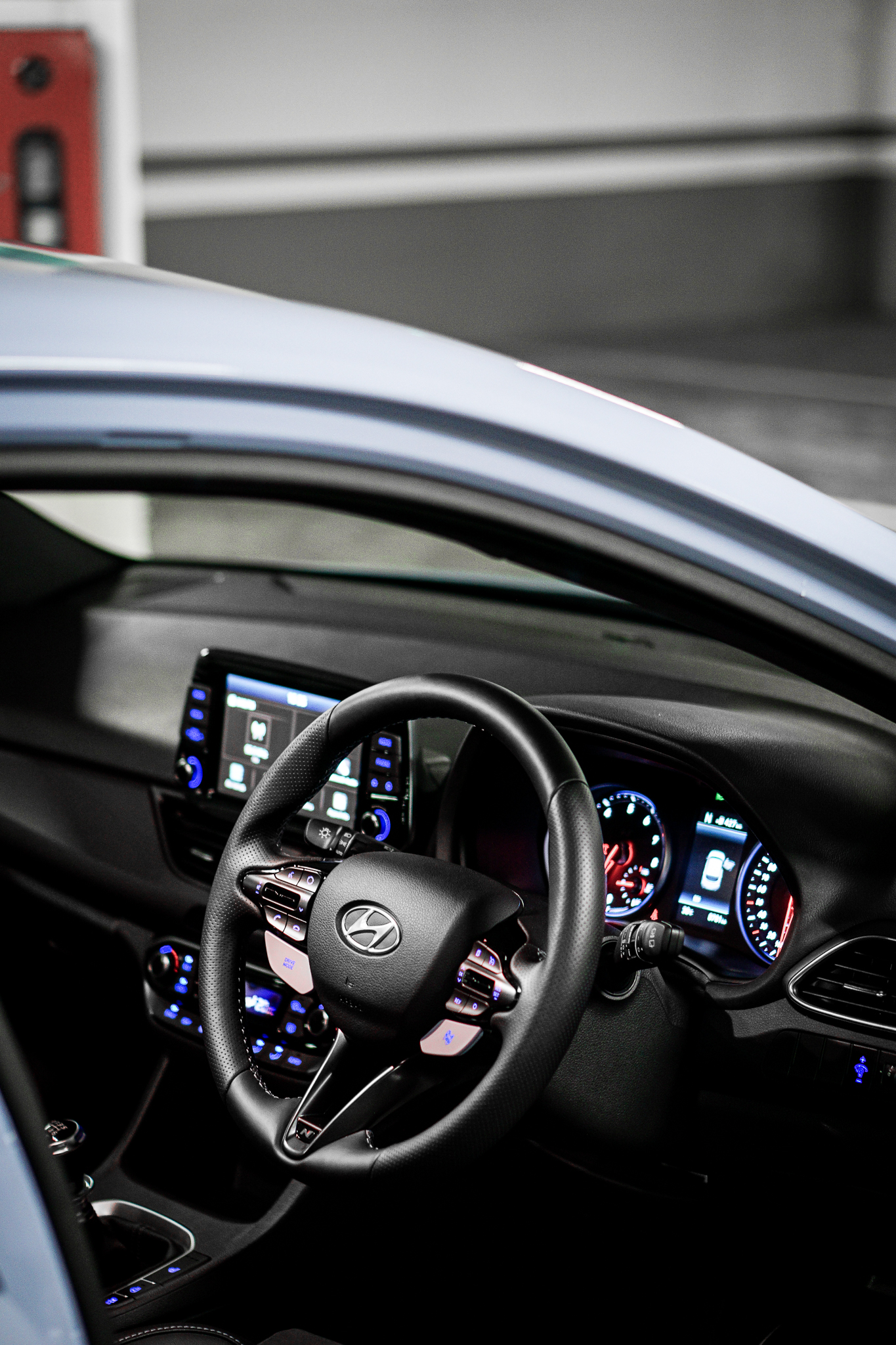 Steering wheel with N buttons lit blue, dash and instrument cluster
