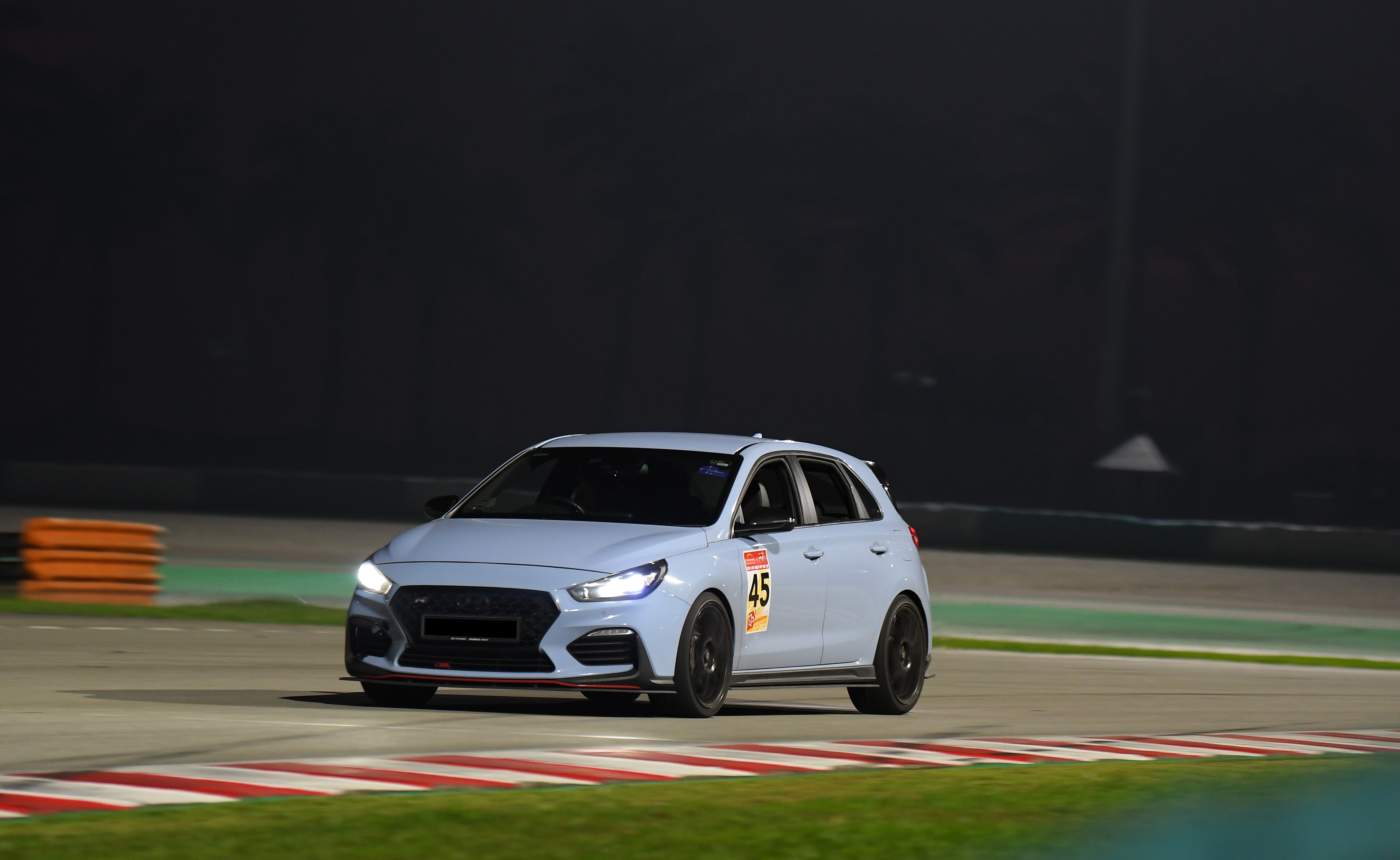Night track action under floodlights