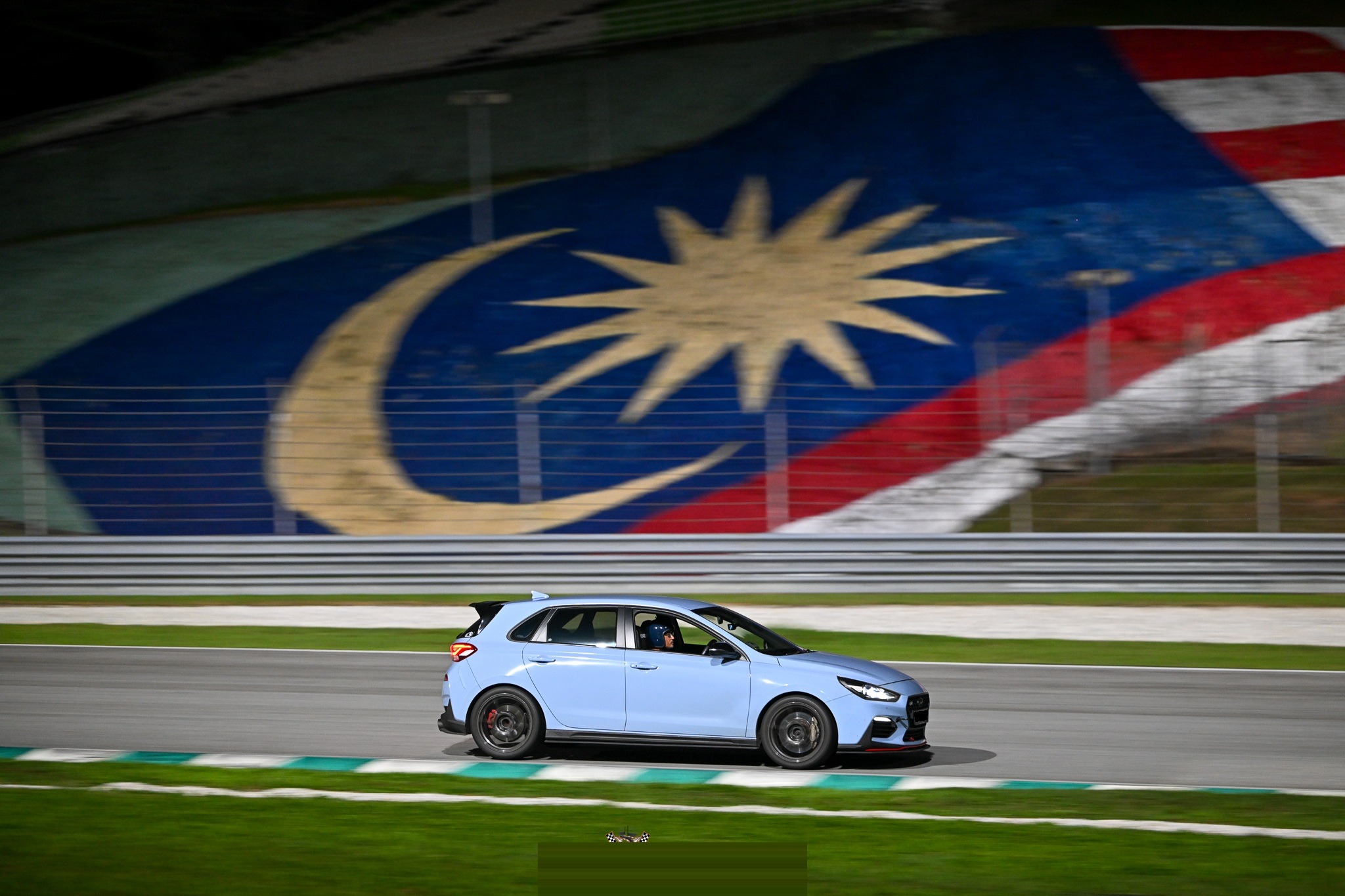 Side panning past the Malaysia flag mural