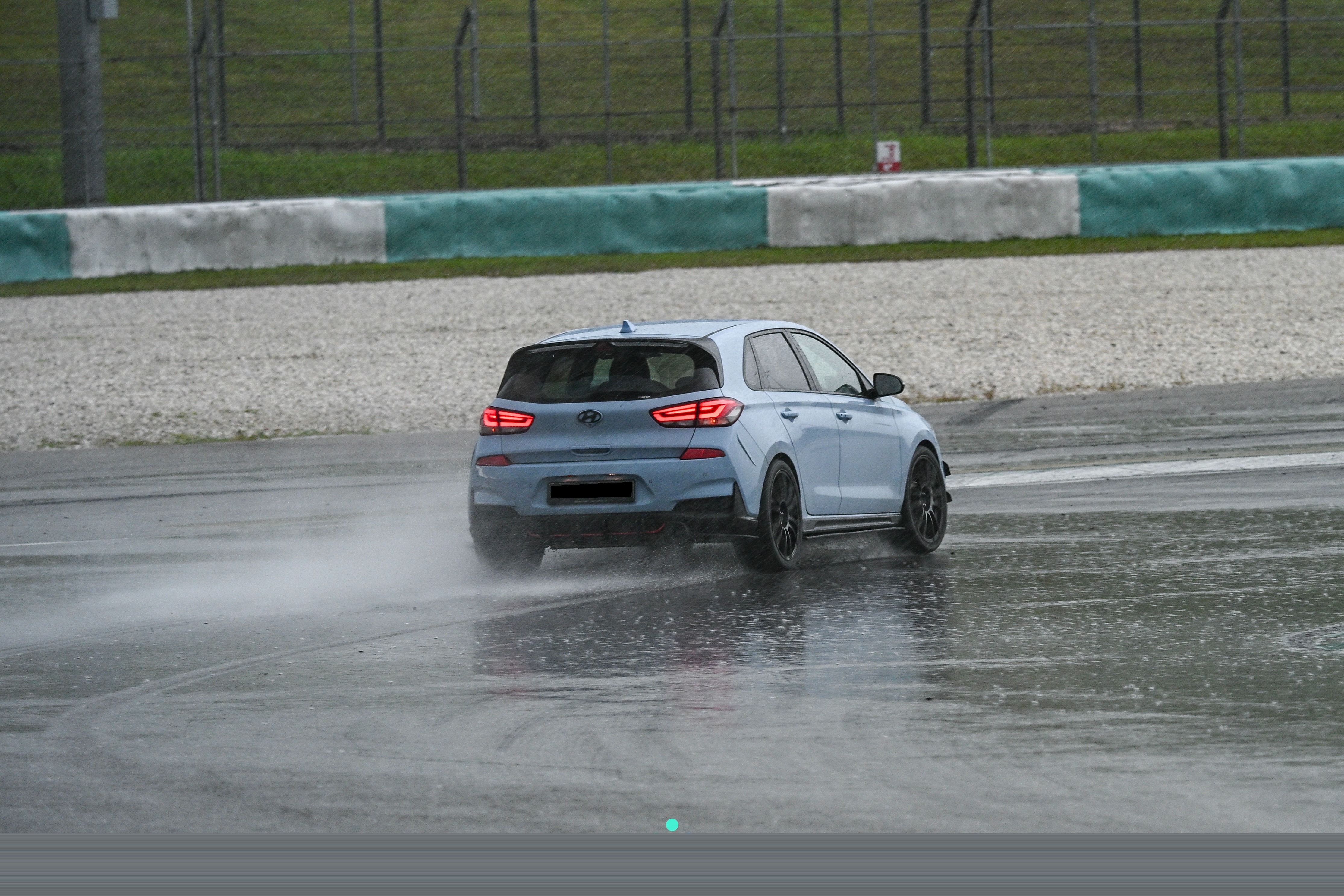 Wet rear, brake lights on, spray off the rear tyres