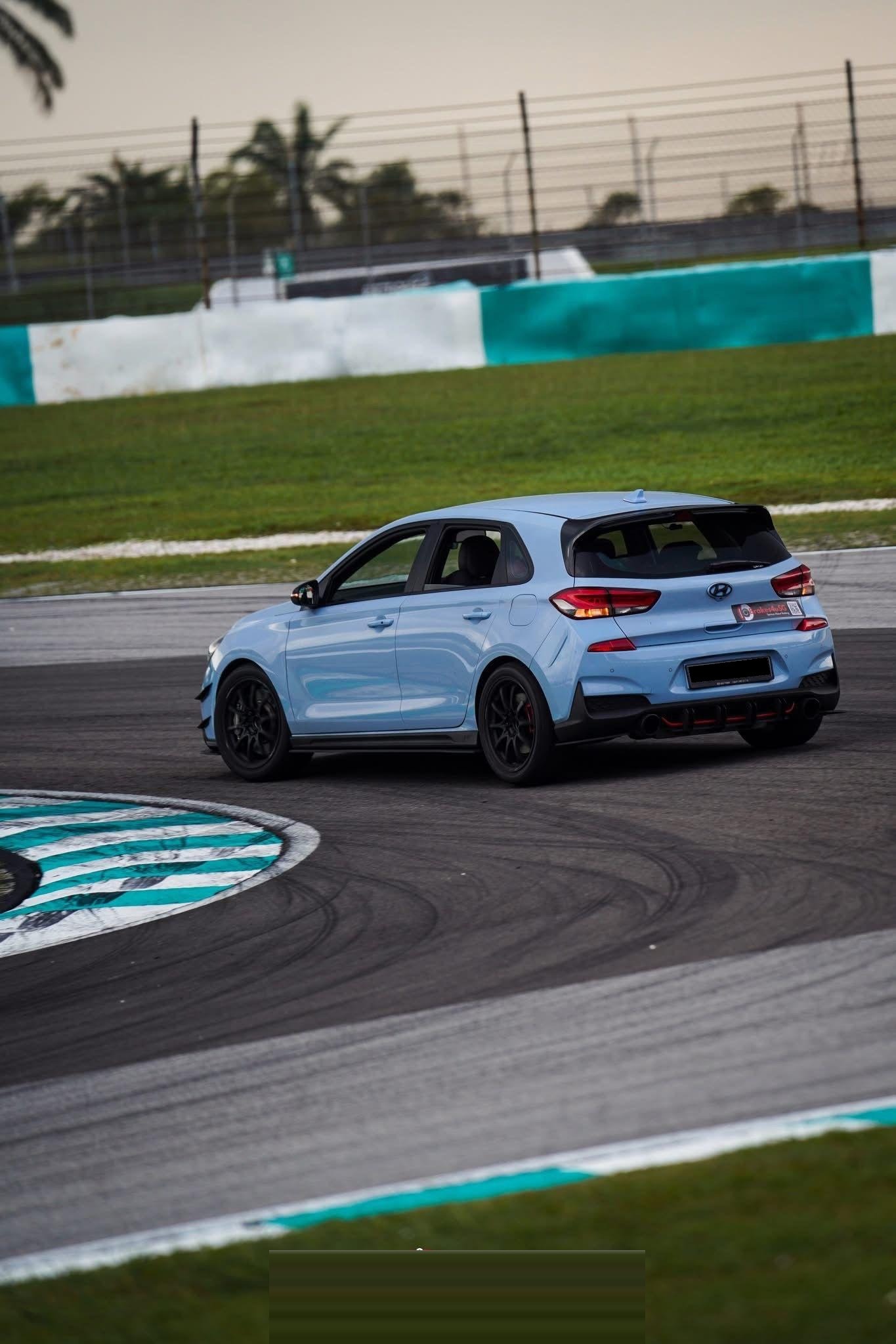 Rear three-quarter, exiting the hairpin