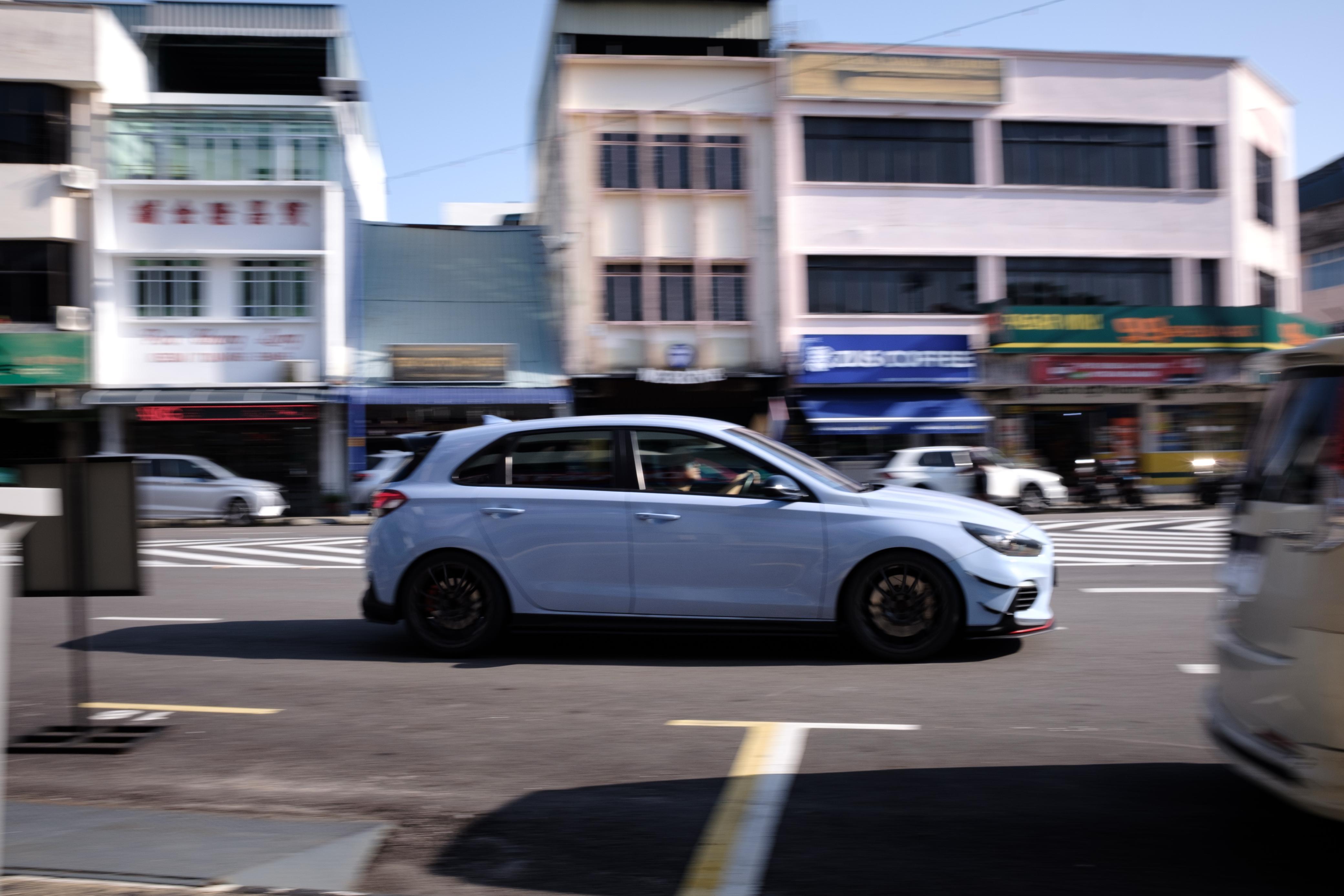 Side panning through Johor shophouses on the convoy north