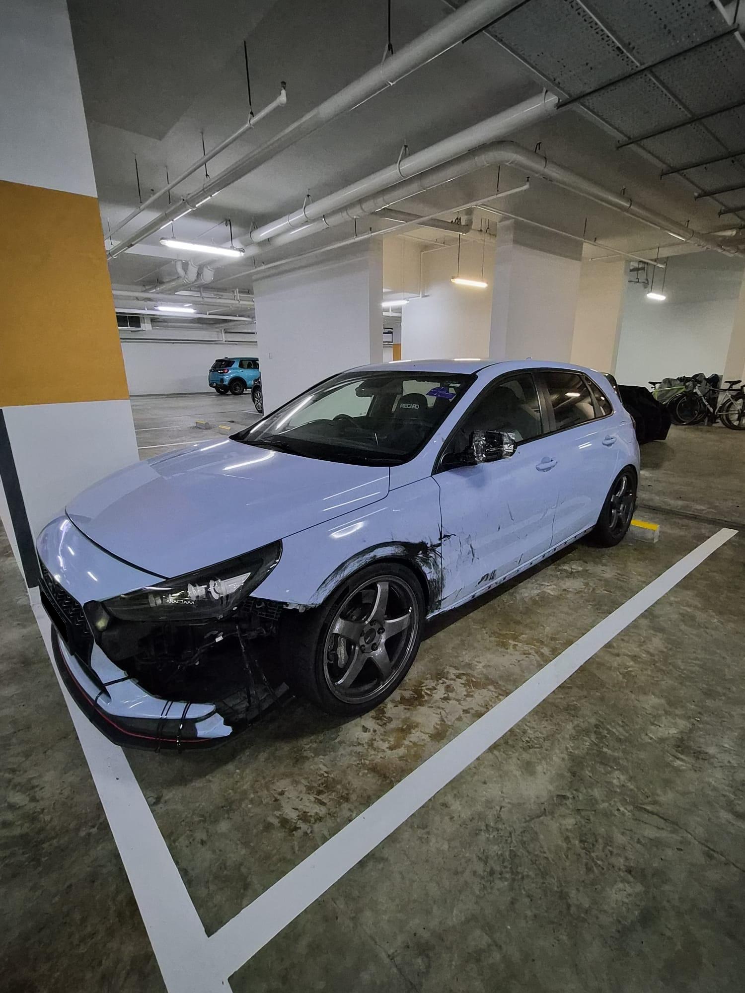 Full side profile in the carpark, nose stripped, left side scraped end to end