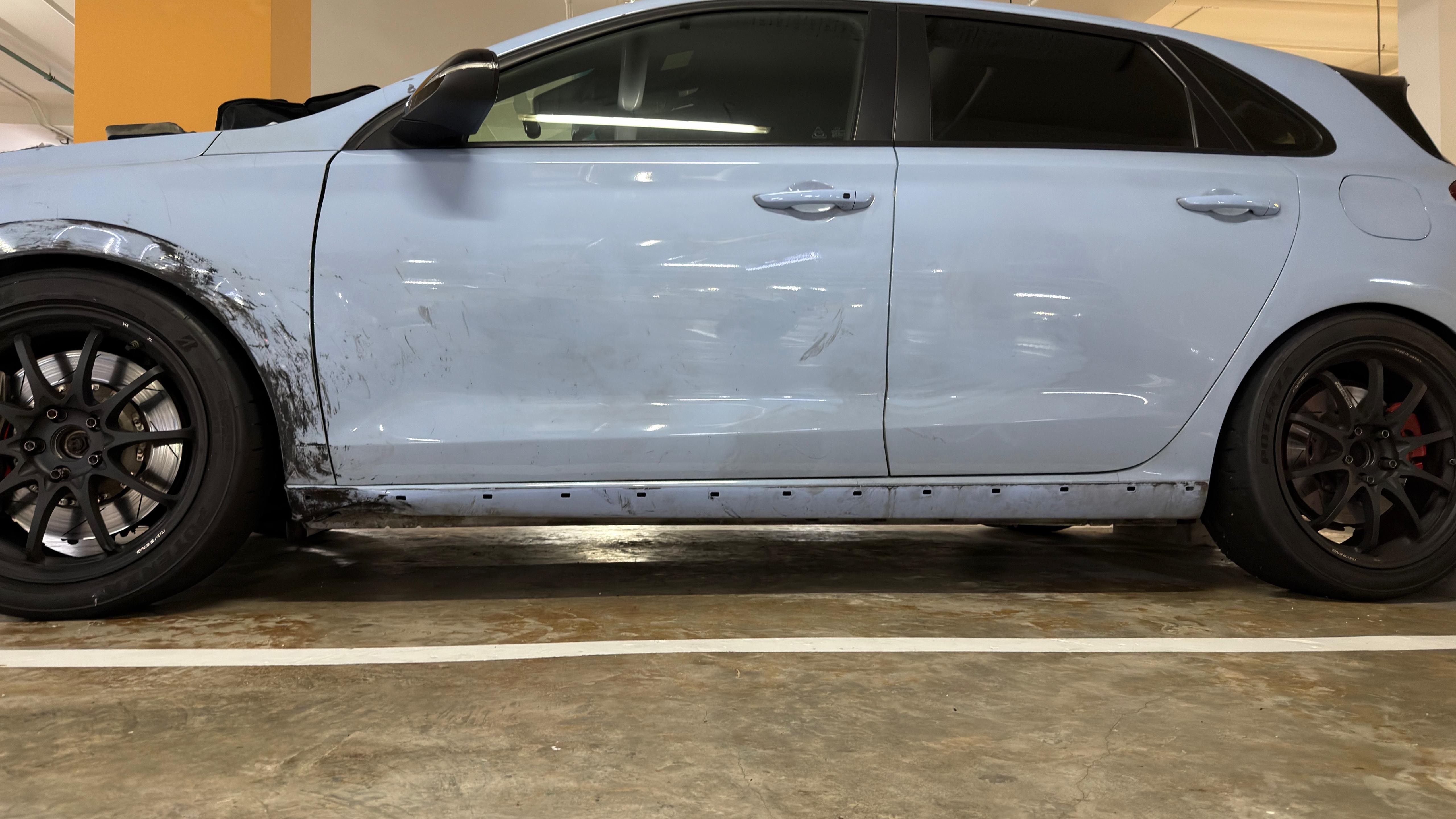 Wide side view, damage limited to dents and scraps, sill marked along its length