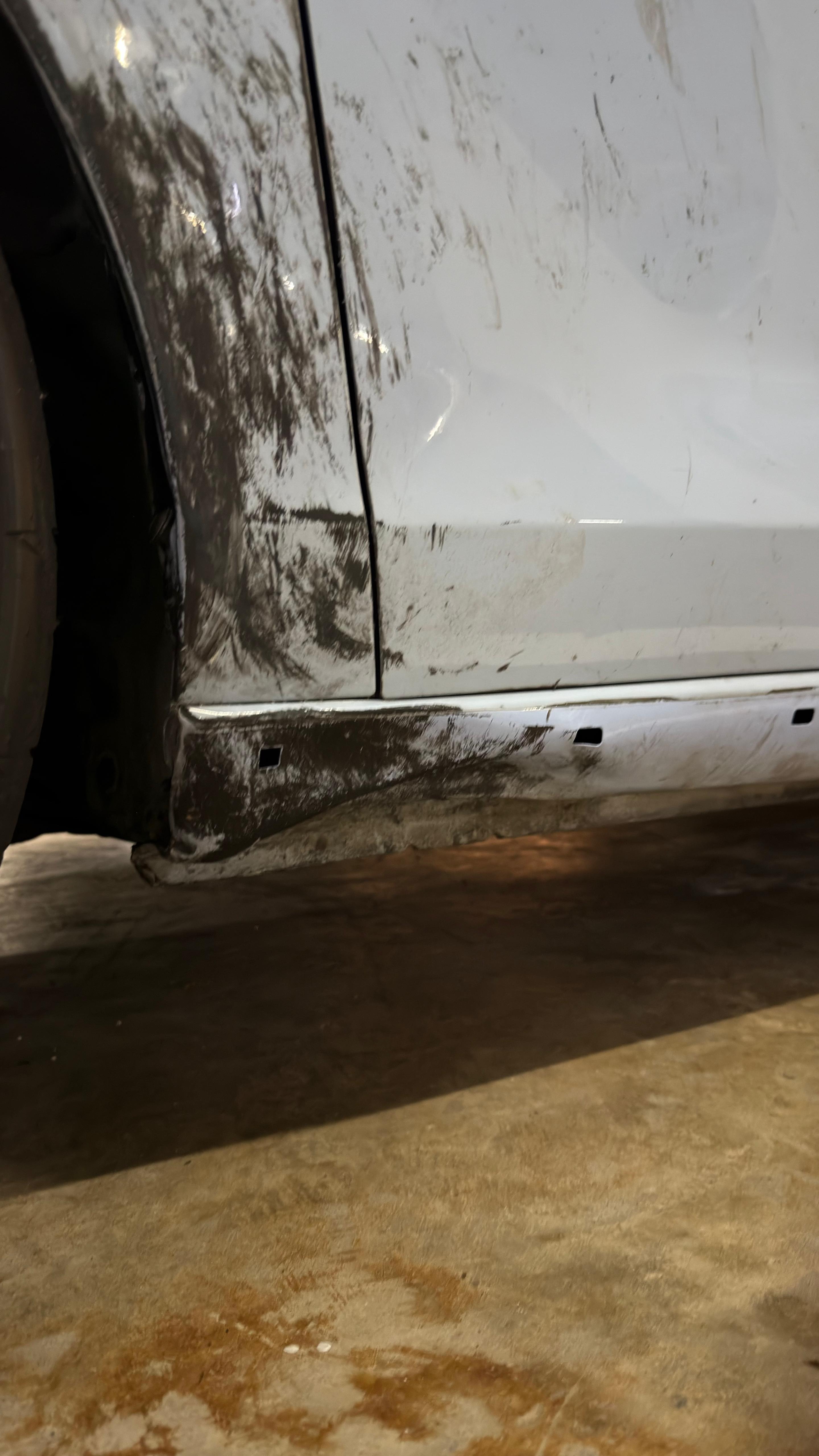 Sill and rocker panel torn and scraped, close detail