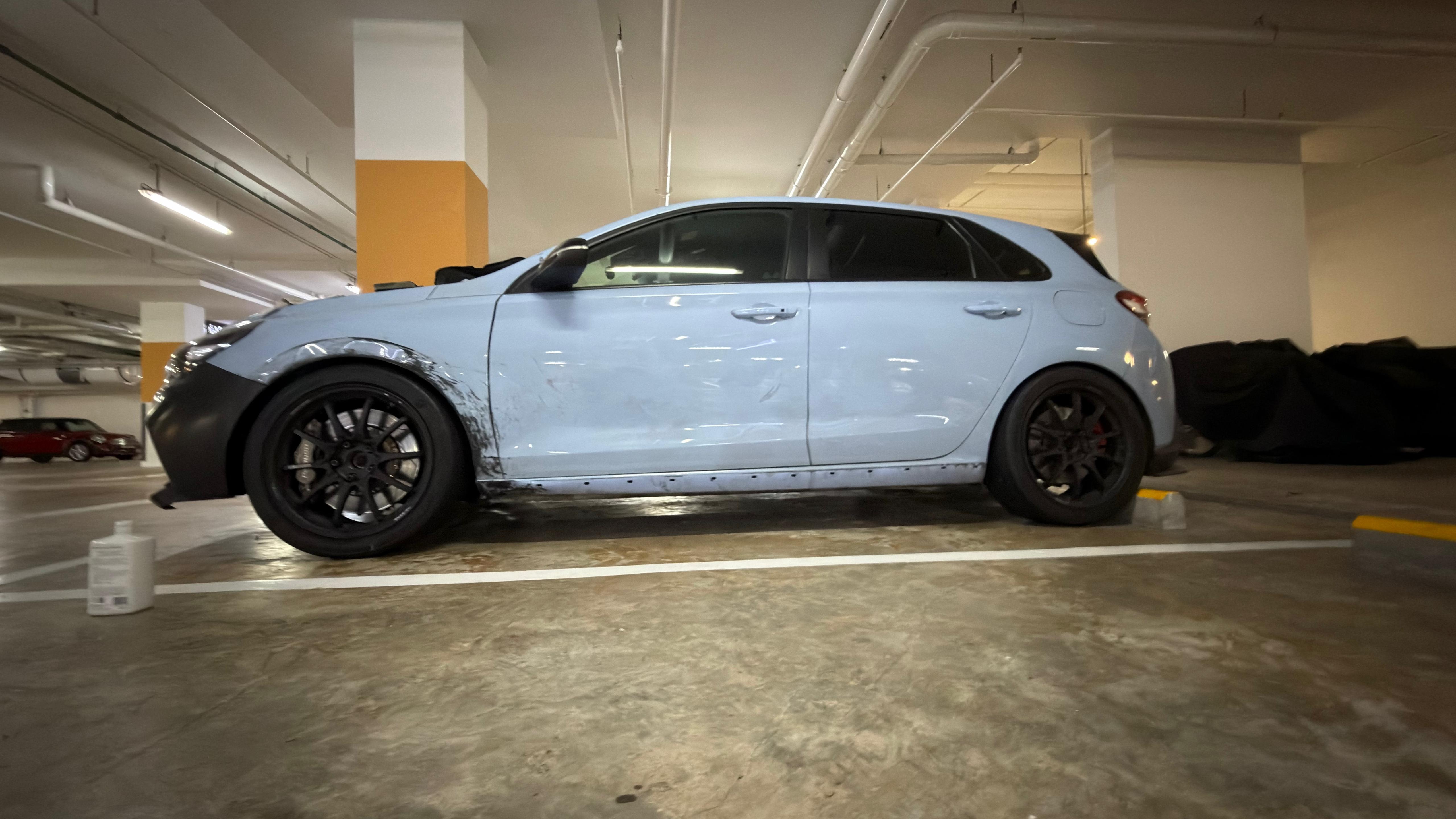 Side profile at rest, with the unpainted front bumper.