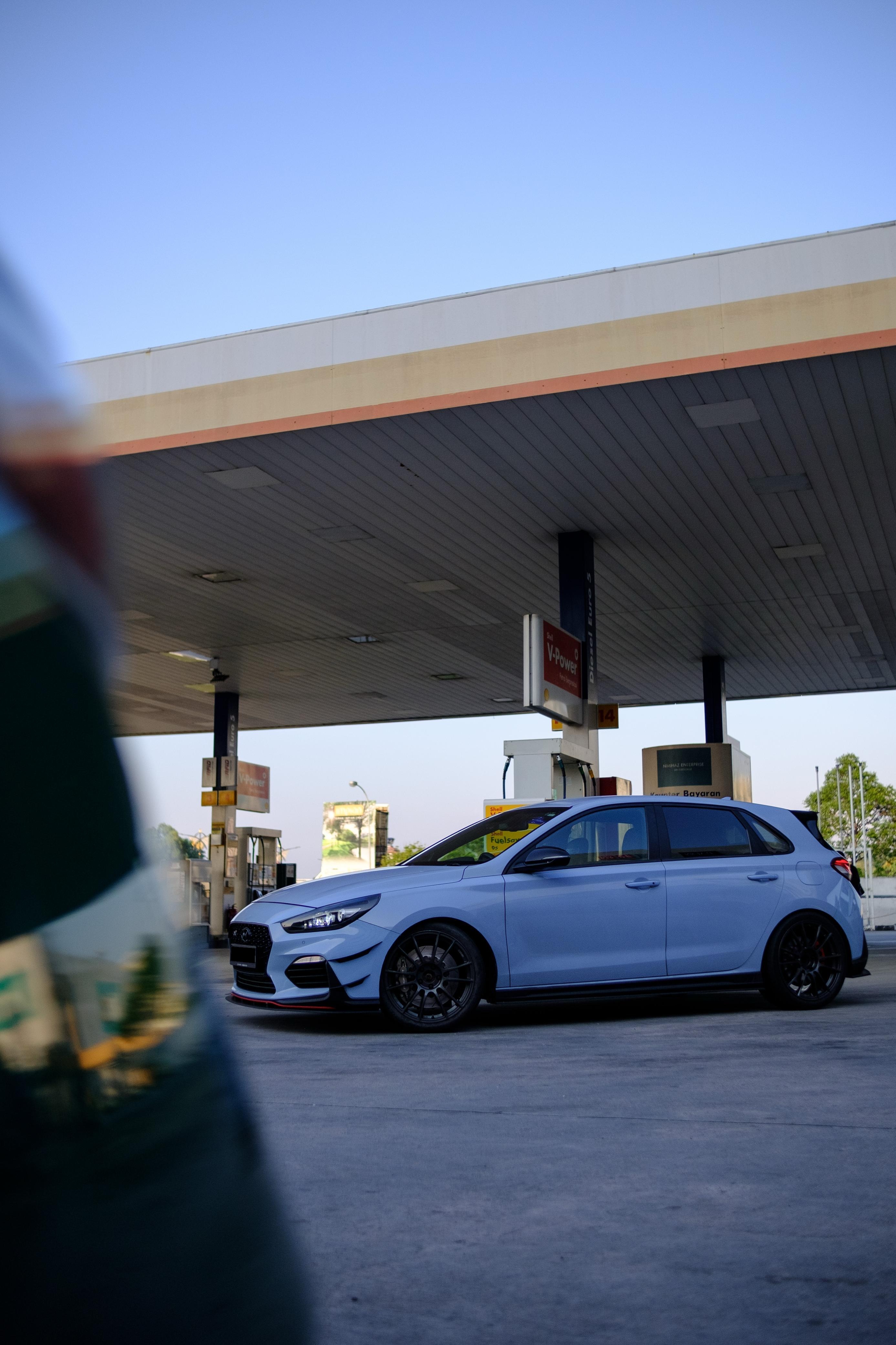 White i30 N parked under a Shell V-Power canopy at dusk